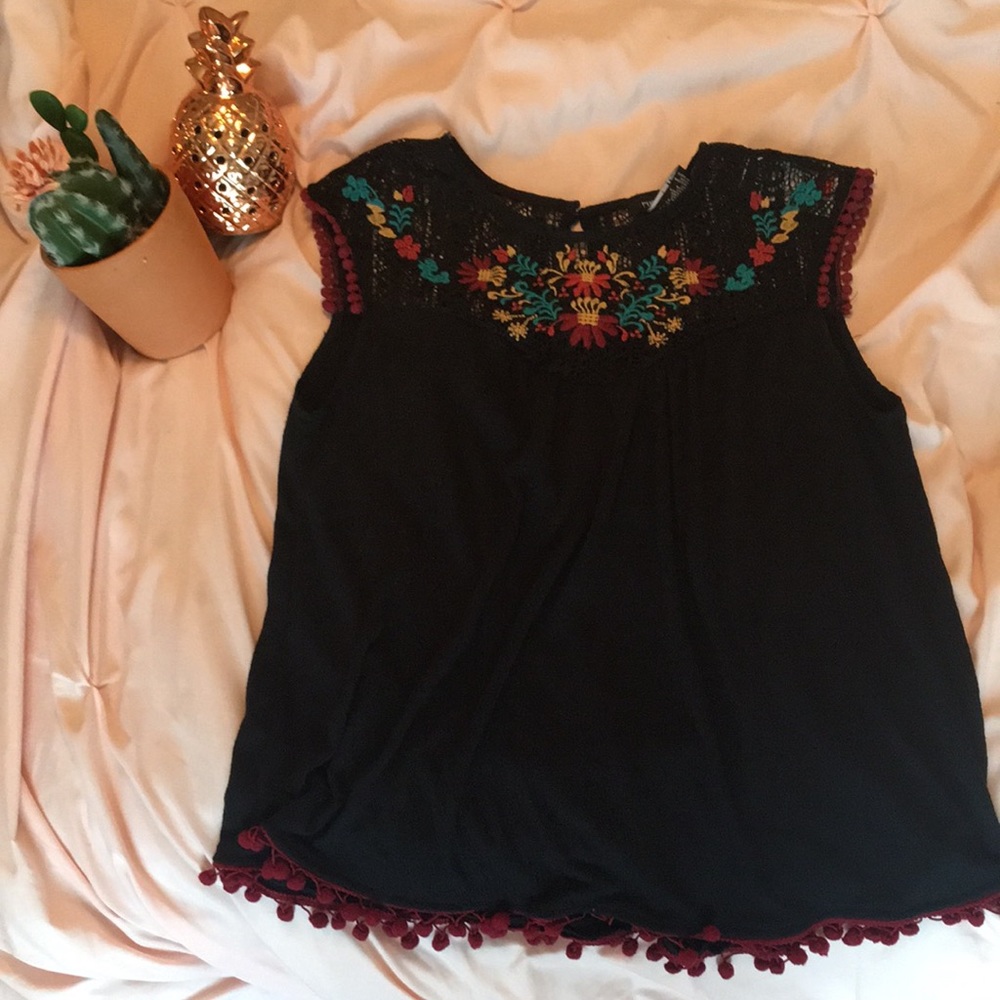 Embroidered blouse with fringe trim on the bottom